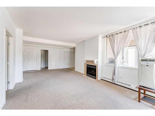 102-2316 17B Street Sw, Calgary, AB - Indoor With Fireplace