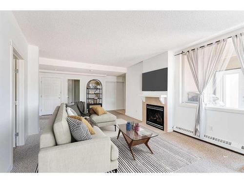 102-2316 17B Street Sw, Calgary, AB - Indoor Photo Showing Living Room With Fireplace