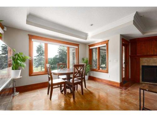 10-154029 264 Street West, Rural Foothills County, AB - Indoor Photo Showing Dining Room With Fireplace