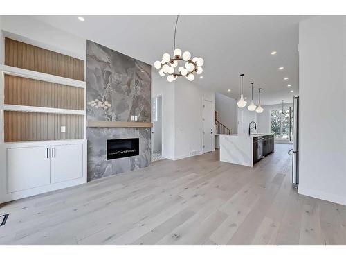 1141 Richland Road Ne, Calgary, AB - Indoor Photo Showing Other Room With Fireplace