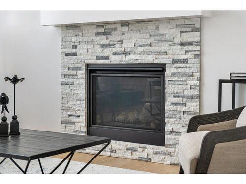 230 Creekside Way Sw, Calgary, AB - Indoor Photo Showing Living Room With Fireplace