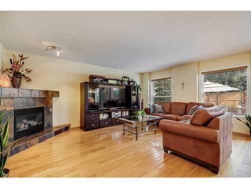 77 Rockbluff Place Nw, Calgary, AB - Indoor Photo Showing Living Room With Fireplace