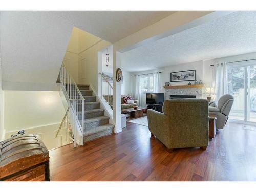 42-200 Shawnessy Drive Sw, Calgary, AB - Indoor Photo Showing Living Room With Fireplace