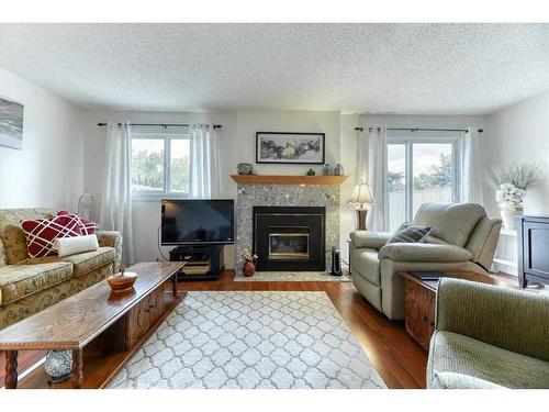 42-200 Shawnessy Drive Sw, Calgary, AB - Indoor Photo Showing Living Room With Fireplace