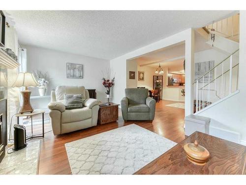 42-200 Shawnessy Drive Sw, Calgary, AB - Indoor Photo Showing Living Room With Fireplace