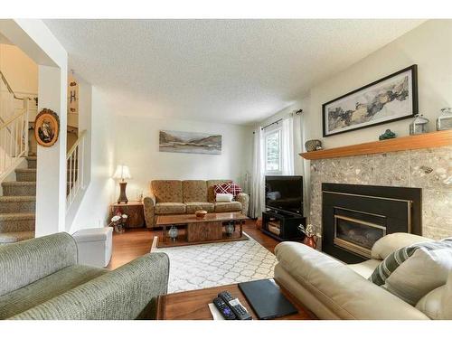 42-200 Shawnessy Drive Sw, Calgary, AB - Indoor Photo Showing Living Room With Fireplace