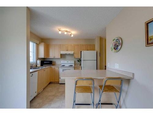 42 Eversyde Common Sw, Calgary, AB - Indoor Photo Showing Kitchen With Double Sink