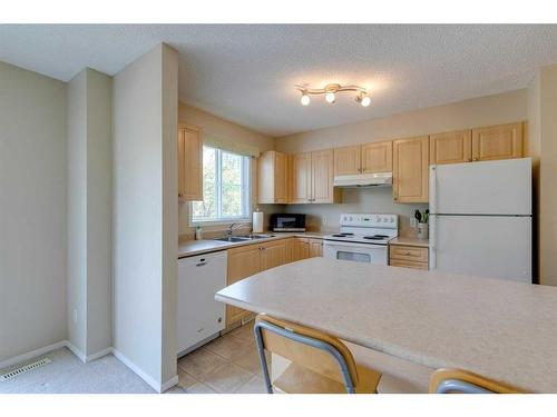 42 Eversyde Common Sw, Calgary, AB - Indoor Photo Showing Kitchen With Double Sink