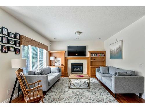 11 Evercreek Bluffs Road Sw, Calgary, AB - Indoor Photo Showing Living Room With Fireplace