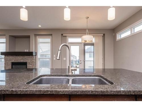 85 Sherwood Heights Nw, Calgary, AB - Indoor Photo Showing Kitchen With Fireplace With Double Sink