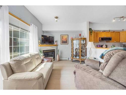 280-223 Tuscany Springs Boulevard Nw, Calgary, AB - Indoor Photo Showing Living Room With Fireplace