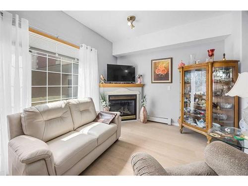 280-223 Tuscany Springs Boulevard Nw, Calgary, AB - Indoor Photo Showing Living Room With Fireplace