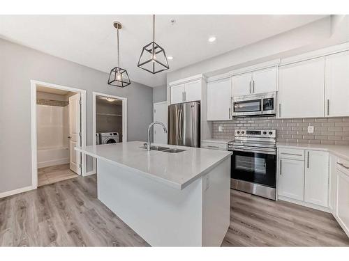 215-4250 Seton Drive, Calgary, AB - Indoor Photo Showing Kitchen With Double Sink With Upgraded Kitchen