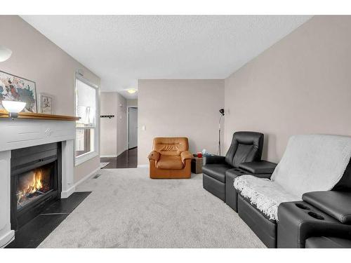 39-3200 60 Street Ne, Calgary, AB - Indoor Photo Showing Living Room With Fireplace