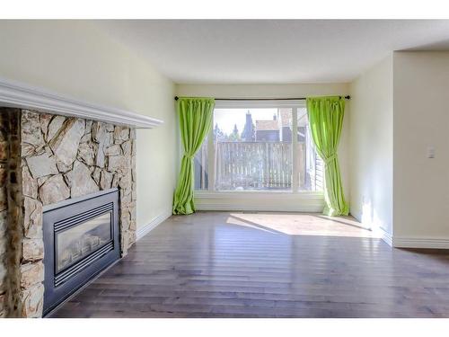 174-77 Glamis Green Sw, Calgary, AB - Indoor Photo Showing Living Room With Fireplace