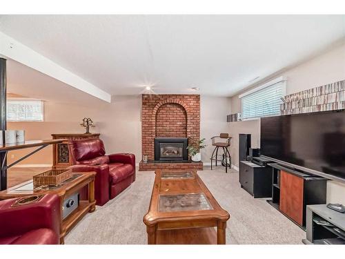 47 Lake Wapta Rise Se, Calgary, AB - Indoor Photo Showing Living Room With Fireplace