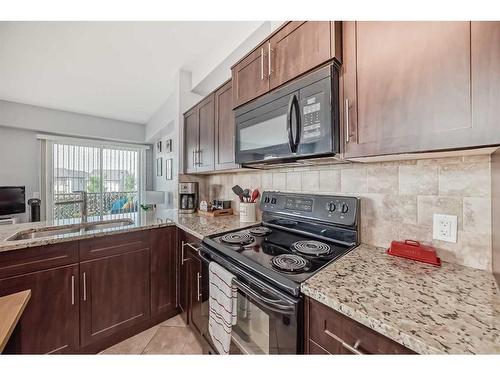 1314-1540 Sherwood Boulevard Nw, Calgary, AB - Indoor Photo Showing Kitchen With Double Sink