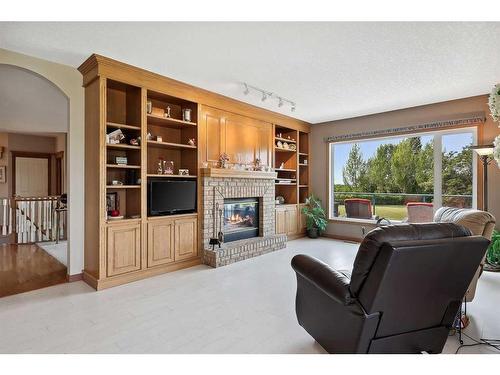 220 Country Lane Drive, Rural Rocky View County, AB - Indoor Photo Showing Living Room With Fireplace