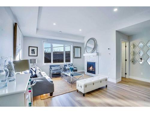 2-2633 1 Avenue Nw, Calgary, AB - Indoor Photo Showing Living Room With Fireplace