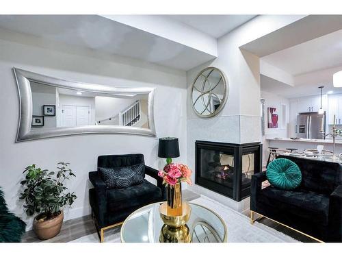 1-2633 1 Avenue Nw, Calgary, AB - Indoor Photo Showing Living Room With Fireplace