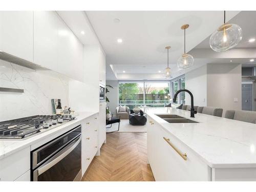 108-8445 Broadcast Avenue Sw, Calgary, AB - Indoor Photo Showing Kitchen With Double Sink With Upgraded Kitchen