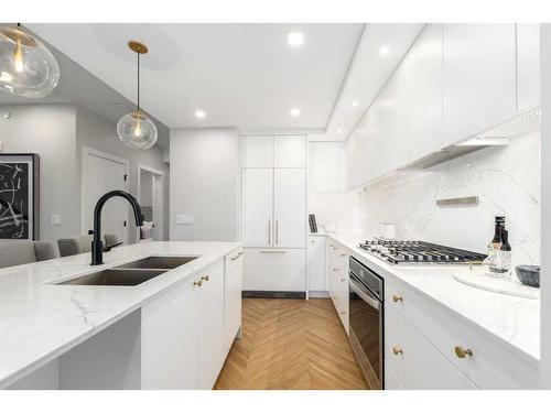 108-8445 Broadcast Avenue Sw, Calgary, AB - Indoor Photo Showing Kitchen With Double Sink With Upgraded Kitchen