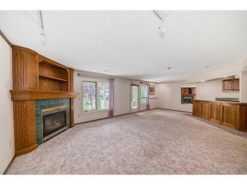 101 Arbour Cliff Close Nw, Calgary, AB - Indoor With Fireplace