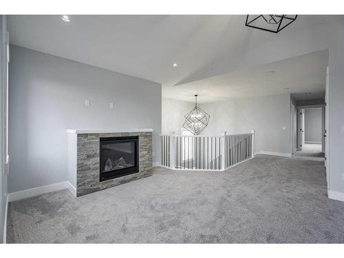 1435 Scarlett Ranch Boulevard, Carstairs, AB - Indoor Photo Showing Living Room With Fireplace