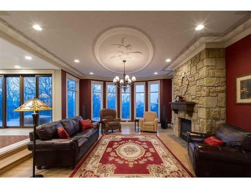 16 Wolfwillow Lane, Rural Rocky View County, AB - Indoor Photo Showing Living Room With Fireplace