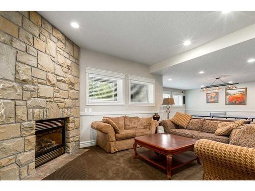 16 Wolfwillow Lane, Rural Rocky View County, AB - Indoor Photo Showing Living Room With Fireplace