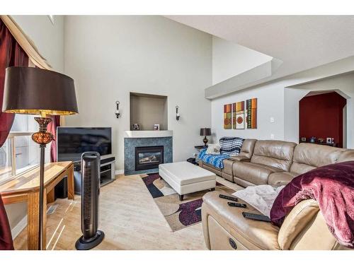 140 Arbour Butte Road Nw, Calgary, AB - Indoor Photo Showing Living Room With Fireplace