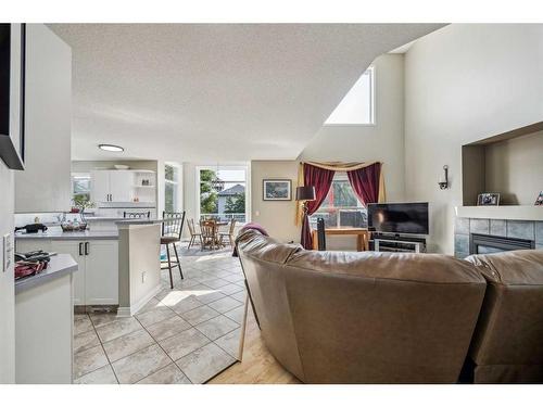 140 Arbour Butte Road Nw, Calgary, AB - Indoor Photo Showing Living Room With Fireplace