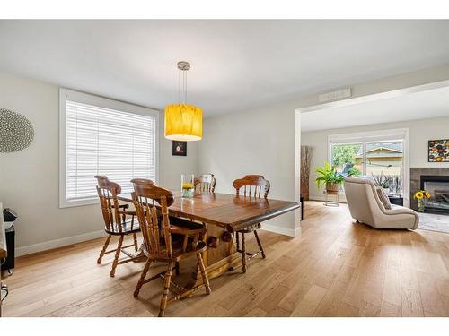 1108 Lake Placid Drive Se, Calgary, AB - Indoor Photo Showing Dining Room With Fireplace