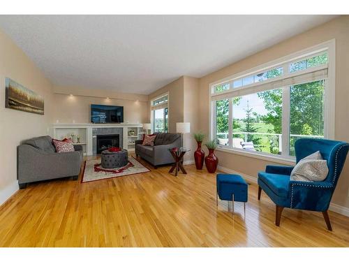 22 Discovery Woods Villas Sw, Calgary, AB - Indoor Photo Showing Living Room With Fireplace