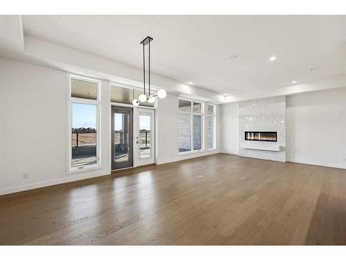 301-120 Marina Cove Se, Calgary, AB - Indoor Photo Showing Other Room With Fireplace