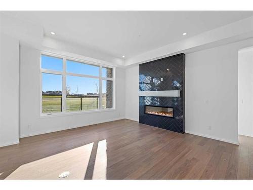 101-120 Marina Cove Se, Calgary, AB - Indoor Photo Showing Living Room With Fireplace