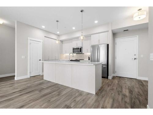 312-38 Quarry Gate Se, Calgary, AB - Indoor Photo Showing Kitchen With Upgraded Kitchen