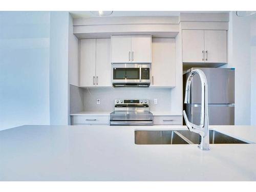 604-33 Merganser Drive, Chestermere, AB - Indoor Photo Showing Kitchen With Double Sink With Upgraded Kitchen