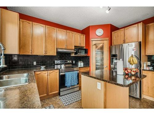 152 Silverado Plains Close Sw, Calgary, AB - Indoor Photo Showing Kitchen With Double Sink