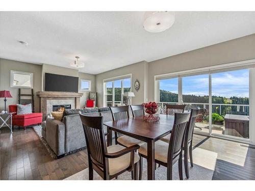 157 Sunset Point, Cochrane, AB - Indoor Photo Showing Other Room With Fireplace