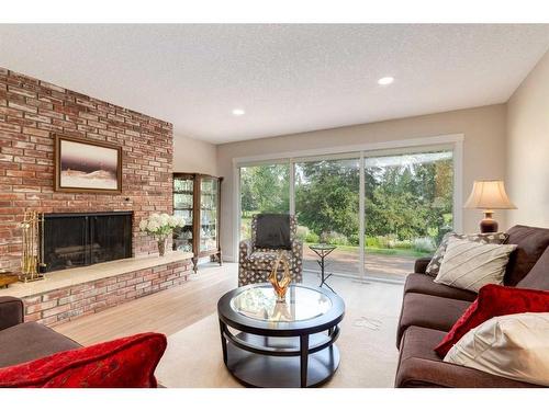 456 Wilderness Drive Se, Calgary, AB - Indoor Photo Showing Living Room With Fireplace