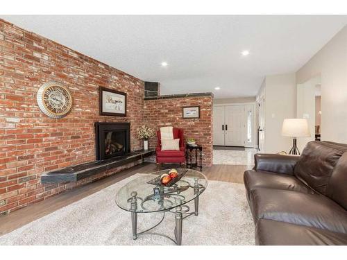 456 Wilderness Drive Se, Calgary, AB - Indoor Photo Showing Living Room With Fireplace