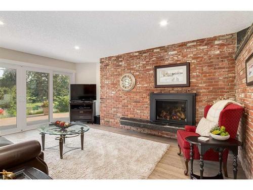 456 Wilderness Drive Se, Calgary, AB - Indoor Photo Showing Living Room With Fireplace