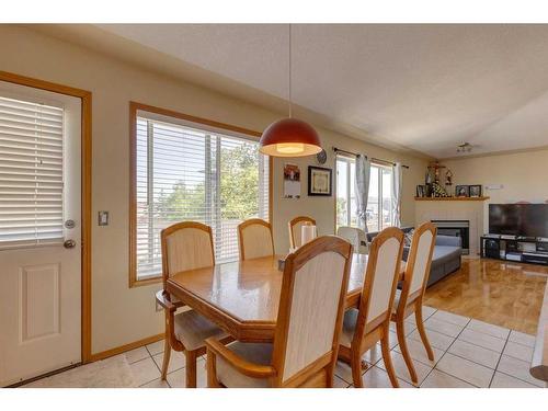 244 Fresno Place Ne, Calgary, AB - Indoor Photo Showing Dining Room With Fireplace