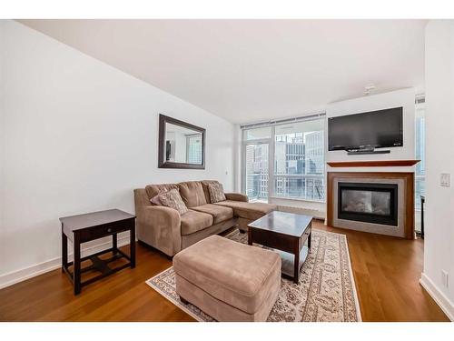 1726-222 Riverfront Avenue Sw, Calgary, AB - Indoor Photo Showing Living Room With Fireplace