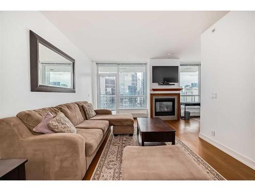 1726-222 Riverfront Avenue Sw, Calgary, AB - Indoor Photo Showing Living Room With Fireplace