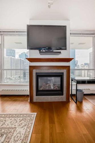 1726-222 Riverfront Avenue Sw, Calgary, AB - Indoor Photo Showing Living Room With Fireplace