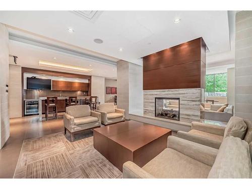 1726-222 Riverfront Avenue Sw, Calgary, AB - Indoor Photo Showing Living Room With Fireplace