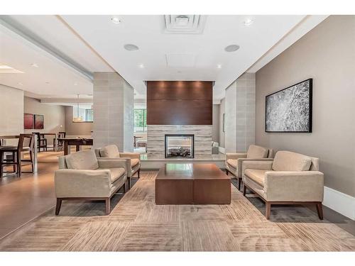 1726-222 Riverfront Avenue Sw, Calgary, AB - Indoor Photo Showing Living Room With Fireplace