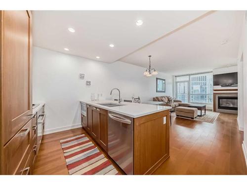 1726-222 Riverfront Avenue Sw, Calgary, AB - Indoor Photo Showing Kitchen With Fireplace With Double Sink